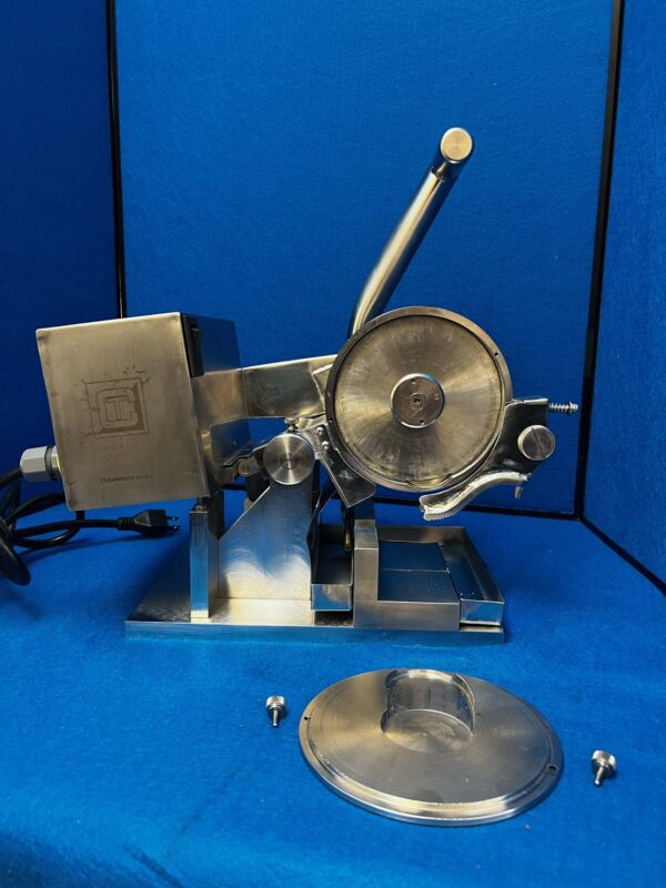 A stainless steel Chop Saw on a blue table.