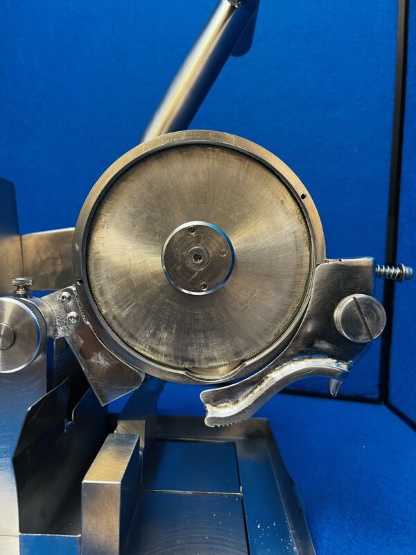 A stainless steel Chop Saw on a blue background.